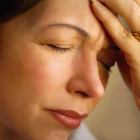 Doctor treating patient in your area with headache